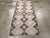 This mid-20th century Turkish Anatolian rug, measuring 3' 2" x 6' 7", presents a striking tribal aesthetic defined by its...