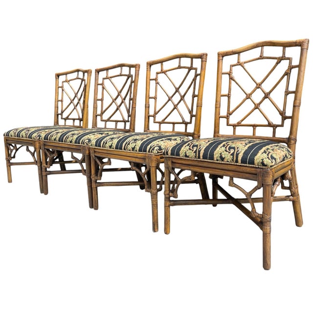 Elegant set of four vintage Palm Beach Regency dining chairs featuring highly desirable fretwork backs with faux bamboo...