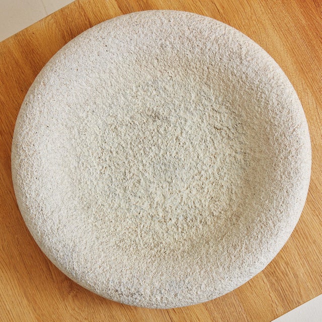 A large Italian bowl or centerpiece from the 1970s. The round, shallow silhouette is composed of ivory hued travertine and...