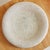 A large Italian bowl or centerpiece from the 1970s. The round, shallow silhouette is composed of ivory hued travertine and...