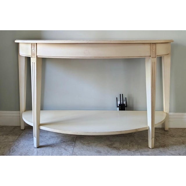 This Gustavian style console table is made by Ethan Allen in the Swedish collection. The table is in antique white finish...