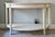 This Gustavian style console table is made by Ethan Allen in the Swedish collection. The table is in antique white finish...