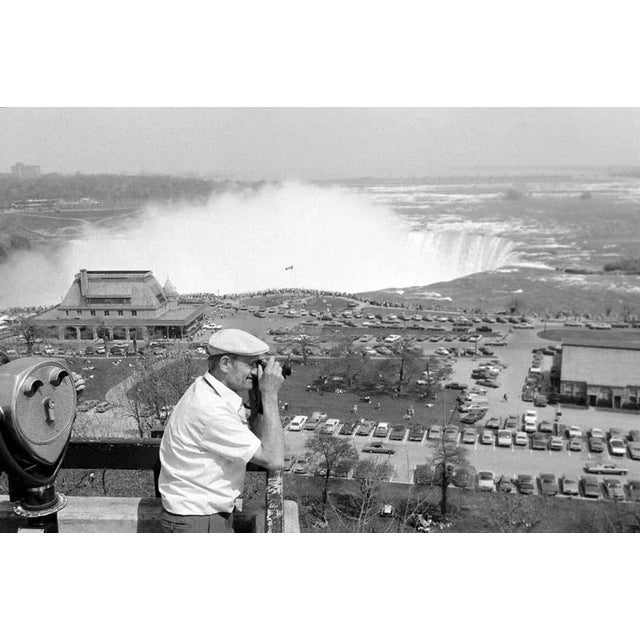 Black and white Print by Erich Andres, ca 1960. Niagara Falls, Canada, 1960s, daytime view of a tourist observing the...