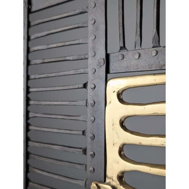 This fireplace screen was designed by David Marshall in Spain during the 1970s, combining hand-forged iron with cast brass...