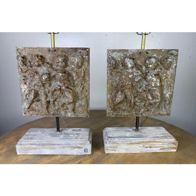 These unique lamps feature cast metal plaques as their central decorative elements, giving them a sculptural and historic...