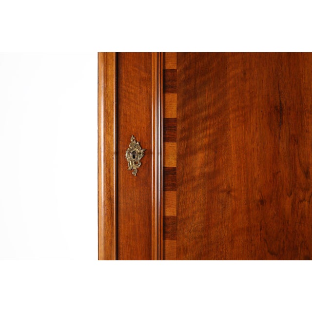A refined mid‑19th‑century French cabinet exemplifying the Romantic period’s devotion to craftsmanship and ornament. The...