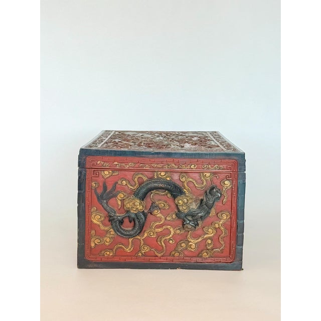 Camphor wood chests were primarily used in China for storing valuables. The red lacquer, along with the gold accents,...