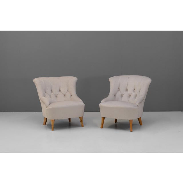 Pair of 1950s Swedish cocktail chairs with beech legs and newly upholstered in a pale pearly-grey velvet.