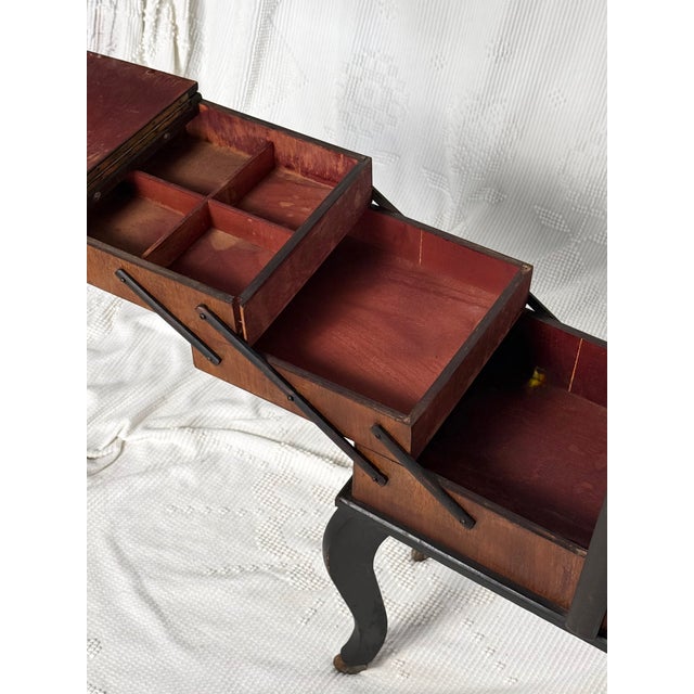 A wooden accordion storage box on curved legs meant for sewing but could be used to store any number of things - jewelry,...