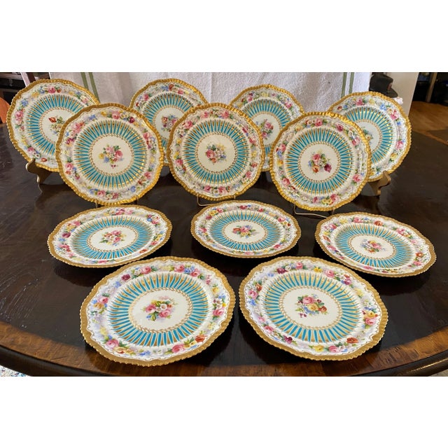 An English Hammersley porcelain decorative Dessert Plate. The center of the plate decorated with a spray of flowers within...