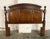 This cherry headboard features a gently arched crest with three raised panels framed by substantial turned posts and...