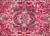 A charming early 20th century Persian Sarouk rug with a central floral medallion living in a field with a mirrored floral...