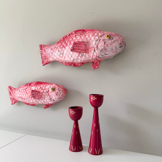 Lovely handcrafted pair of two pink paper mache hanging wall fish. The pair can be displayed against a table top as well.