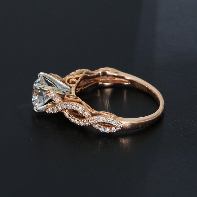 Here is a 14k Rose Gold Engagement Ring with One 0.8ct. H/SI1 Round Diamond Center & Fifty 1mm Accent Diamonds. Ring Size...