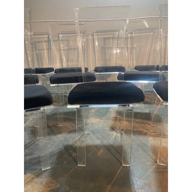 Set of 12 lucite dining chairs Brand unknown Black seat cushions that can easily be replaced Modern design A stylish set...