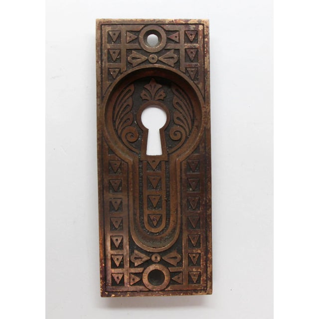 An antique pair of pocket door plates in an Aesthetic style, fashioned from bronze. The original mounting screws are not...