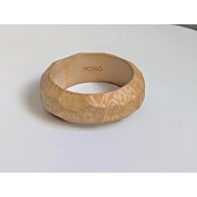Seller delegated shipping, arrives 4-8 days from purchase. Floral pattern dual tone over multi faceted carved wood, a Pono...