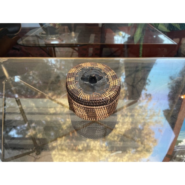 A wonderful wicker woven piece with wood bottom and wood carved turtle on top. Great Looking Piece. Tight Weave with...