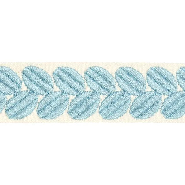 An exuberant embroidered tape with a leaf-like pattern rendered in satin stitching; inspired by a document in our...