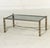 Modernist design constructed with mixed metal finishes and glass. The table is anchored by an inset glass top set within a...