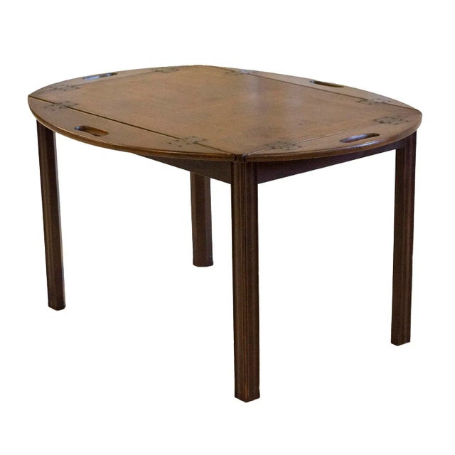 Classic antique mahogany English butlers table with slot head brass screws circa 1920s. The table features fold down...