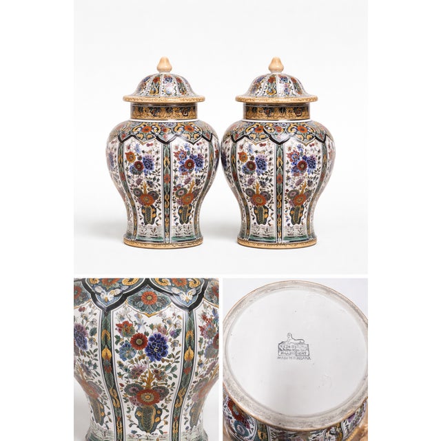 This refined pair of lidded ceramic vases was produced by the renowned Dutch manufacturer De Sphinx, based in Maastricht....