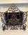 Elegant fireplace screen crafted in ornate cast iron with exceptional scrolling foliate detail and an aged bronze-brown...