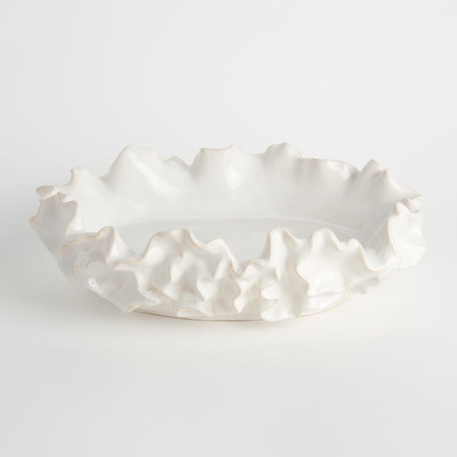 Botanically-inspired with a delicate ruffled, sea life-like edges. A durable stoneware, made with an innovative process,...