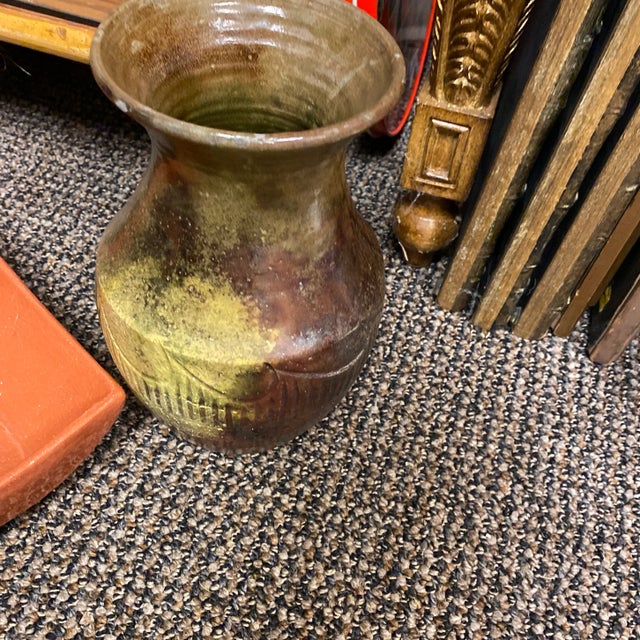 Beautiful African pottery vase. Reflection shows holographic colors certain to catch the eye. Detailed wave pattern....