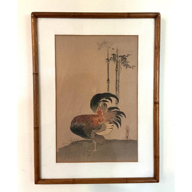 Hand-painted Chinese artwork depicting a proud rooster beneath slender bamboo stalks, executed in ink and watercolor on...