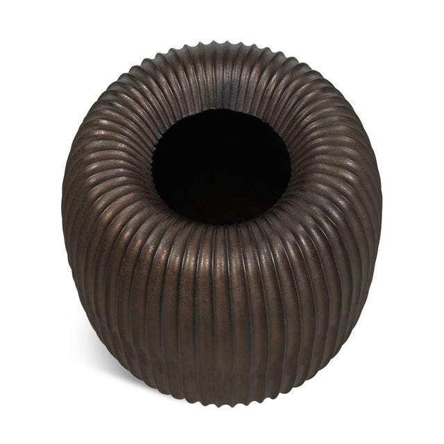 Crafted from cast aluminum, this planter has a round silhouette and deep vertical fluting create a striking interplay of...