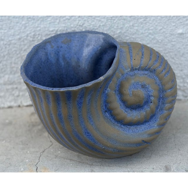 It's a shell (planter) game! You will have no problem coming up with ideas of where to use this studio pottery blue glazed...