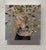 "Harvest" is an oil on silver leaf portrait by Cody Erickson, completed in 2016. A young woman is shown in profile, facing...