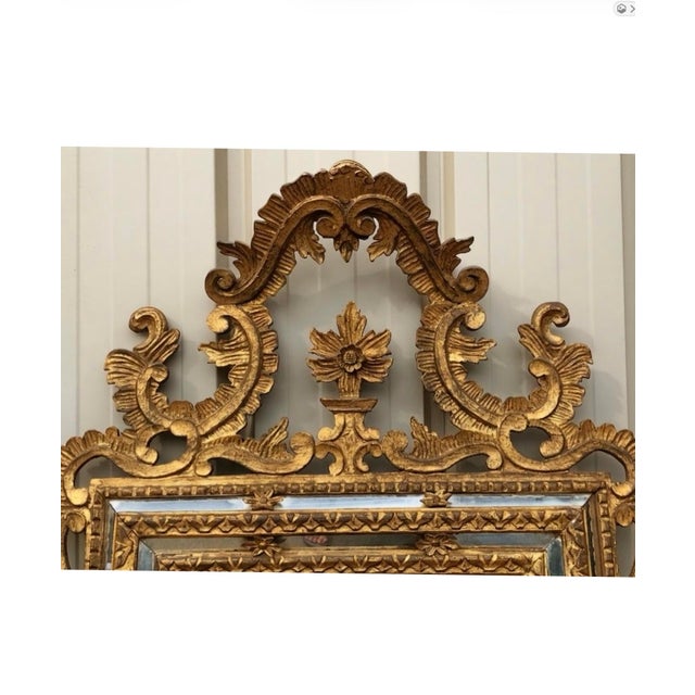 This is a mid-century Italian carved giltwood baroque revival wall mirror distributed by Danby out of Manhattan. This...