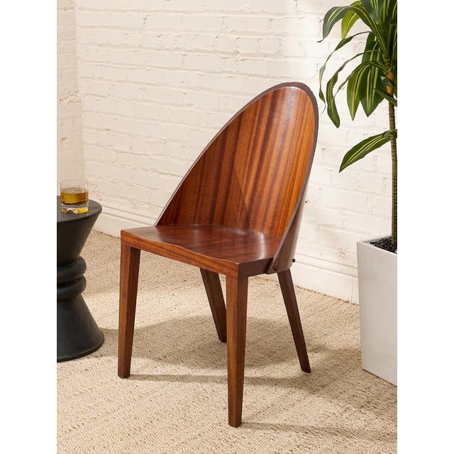 A striking Philippe Starck chair with a beautifully pared-back silhouette and a wonderfully sculptural presence. Crafted...