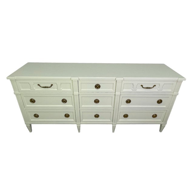 A beautifully refinished dresser by American of Martinsville, executed in a soft off-white lacquer that highlights its...