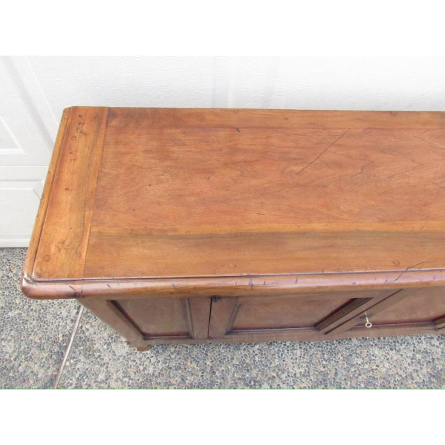 Antique French narrow walnut buffet, c.1850 A well proportioned long and narrow two door buffet in a warm honey color....