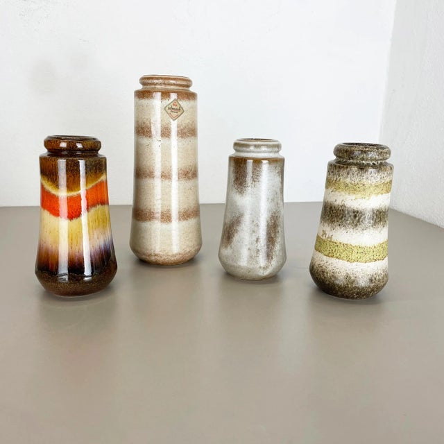 Set of four fat lava art vases Producer: Scheurich, Germany Decade: 1970s These original vintage vases was produced in the...