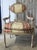 Elegant matched pair of early 20th century Louis XVI Revival armchairs distinguished by carved oval backs, fluted legs,...