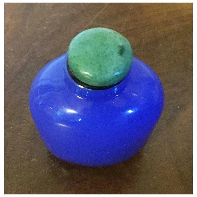 Chinese bright blue Peking glass snuff bottle in the Art Deco manner. Measures 3" tall x 2 1/4" wide. Simple design,...
