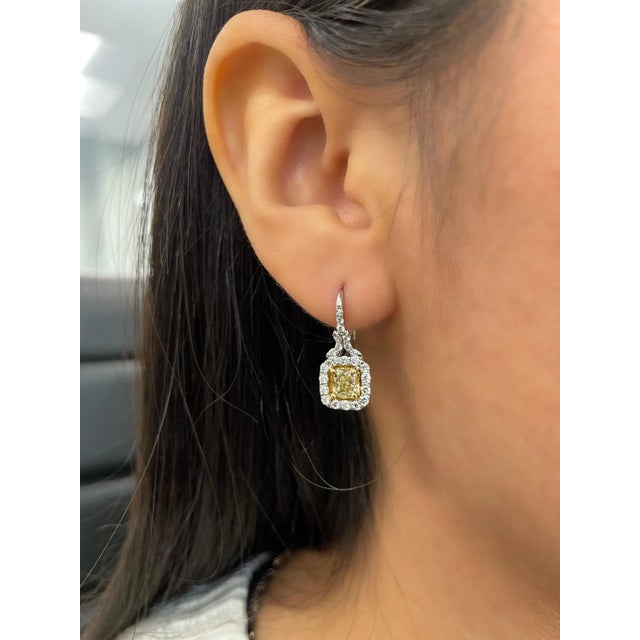 Here is a stunning pair of natural yellow diamond earrings, beautifully crafted in luminous platinum. Each earring...