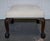 A charming early Victorian footstool featuring classic carved claw-and-ball feet and a beautifully upholstered white suede...