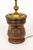 An American Colonial-style turned wood basin lamp with a prominent brass metal plate marked with "1827", a clover, and a...