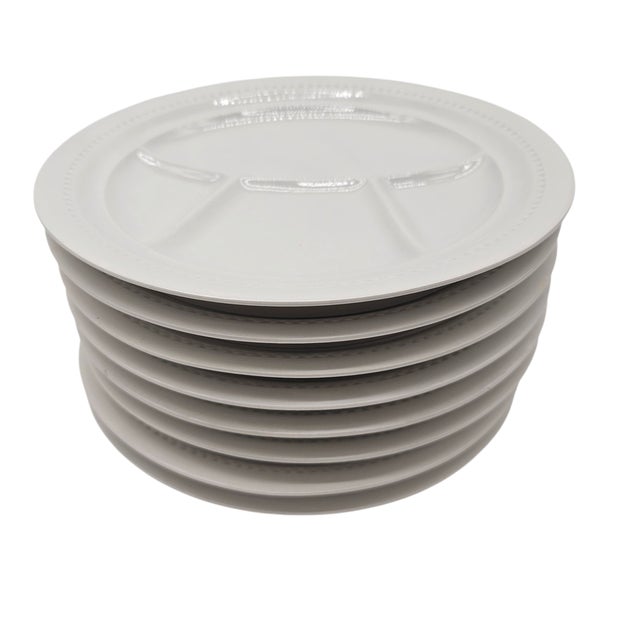 A table whispers civility when set with white so crisp it rivals linen. These French porcelain plates by Keller & Guerin...