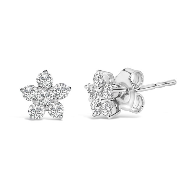 Immerse yourself in the celestial charm of these exquisitely crafted 10K white gold earrings, shaped into delicate stars...