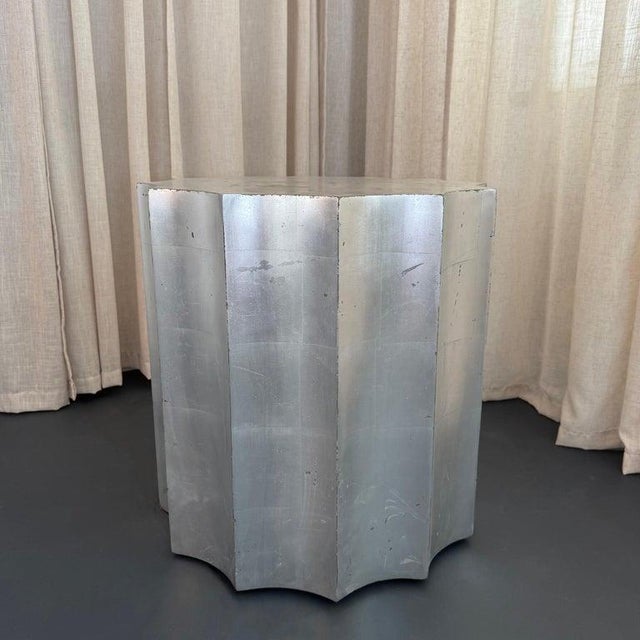 This sculptural, fluted Doric column drum table by The Sirmos Company, draws from classical architecture, executed with a...