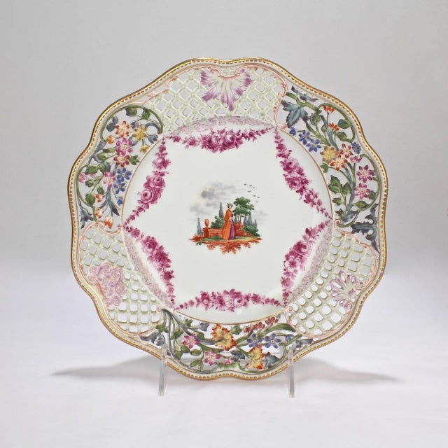 A finely worked pair of antique Dresden reticulated cabinet plates. Each with hand-painted decoration. Diameter: ca. 9 1/2...