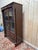 A two-door Empire-style bookcase/display cabinet in solid and veneered mahogany. The upper section consists of two glazed...