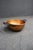 Antique solid copper mixing bowl featuring a rounded form with hand-forged iron side handles secured by copper rivets. The...