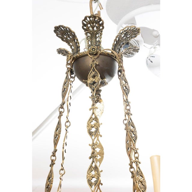 This is an impressive Russian Renaissance Revival bronze chandelier, richly cast and displaying the bold architectural...